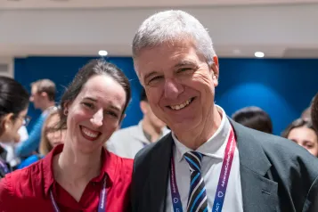 Two people smiling at camera.