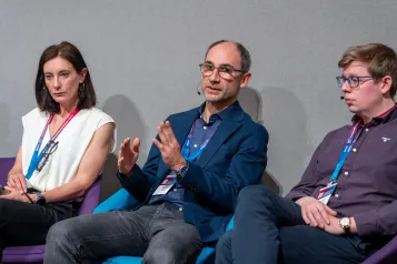 Three people sat in panel discussion.