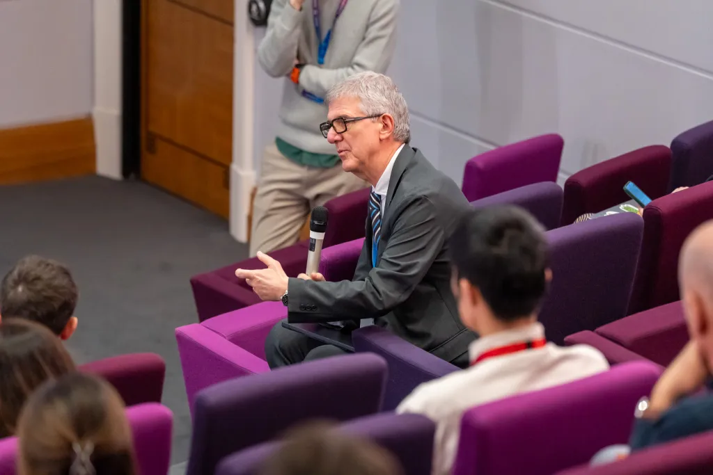 Man in lecture theatre.