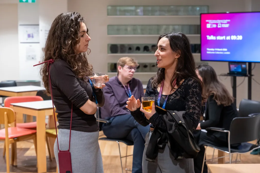 People stood talking at networking reception.